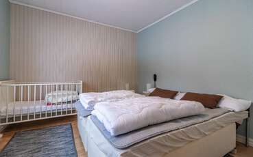 Schlafzimmer mit Doppelbett und Kinderbett Ferienhaus Kläveström