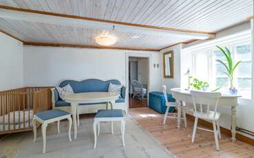 Kleiner Wohnbereich im Schlafzimmer mit Babybett Ferienhaus Södra Kvarn