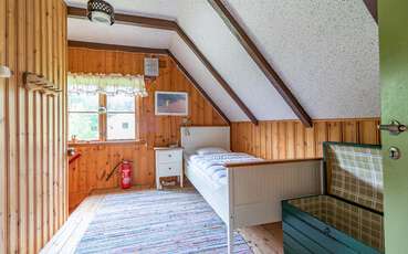 Schlafbereich mit Einzelbett Ferienhaus Tving